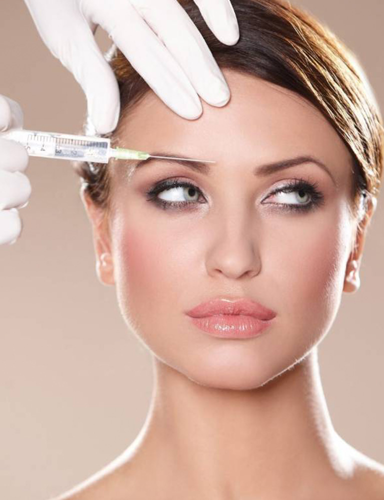 A woman looking away from the camera with a needle on her face